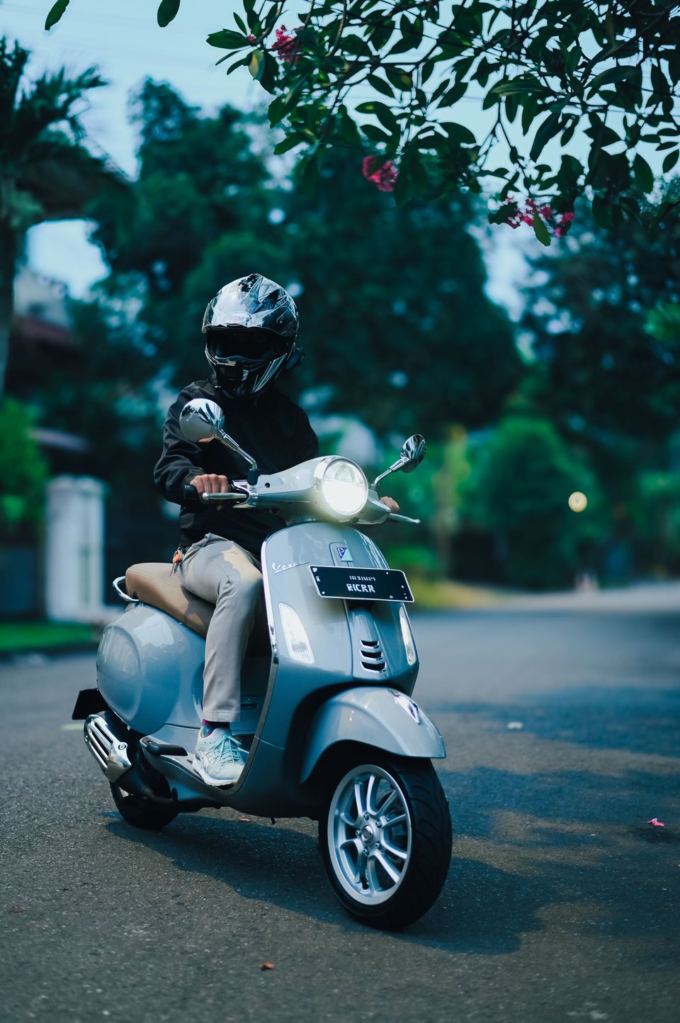 Pupu, the photographer behind Snipandshot, riding a Vespa scooter